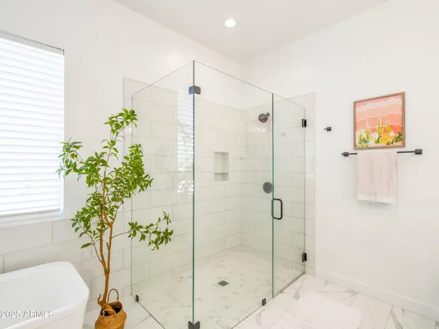 a bathroom with a shower and a sink