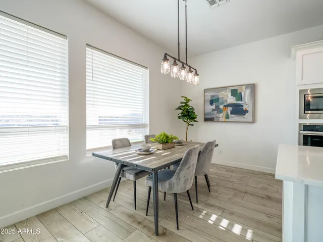 a view of a dining room with furniture window and wooden floor