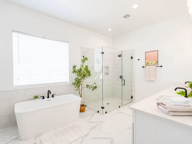 a bathroom with a tub sink and shower