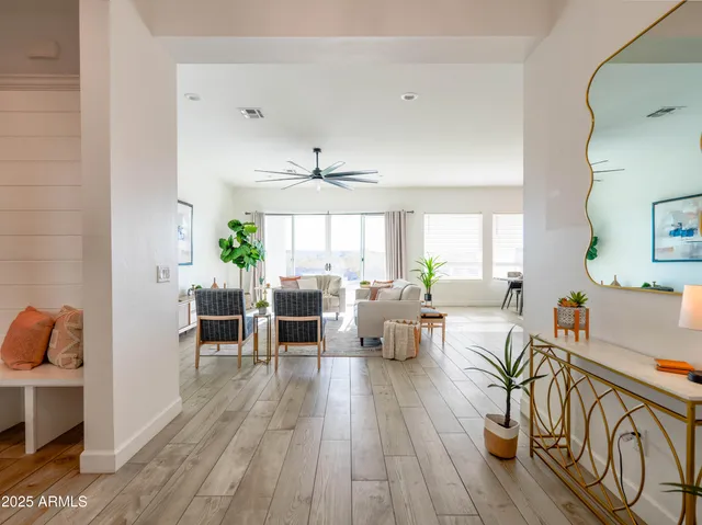 a living room with furniture a wooden floor and a fireplace