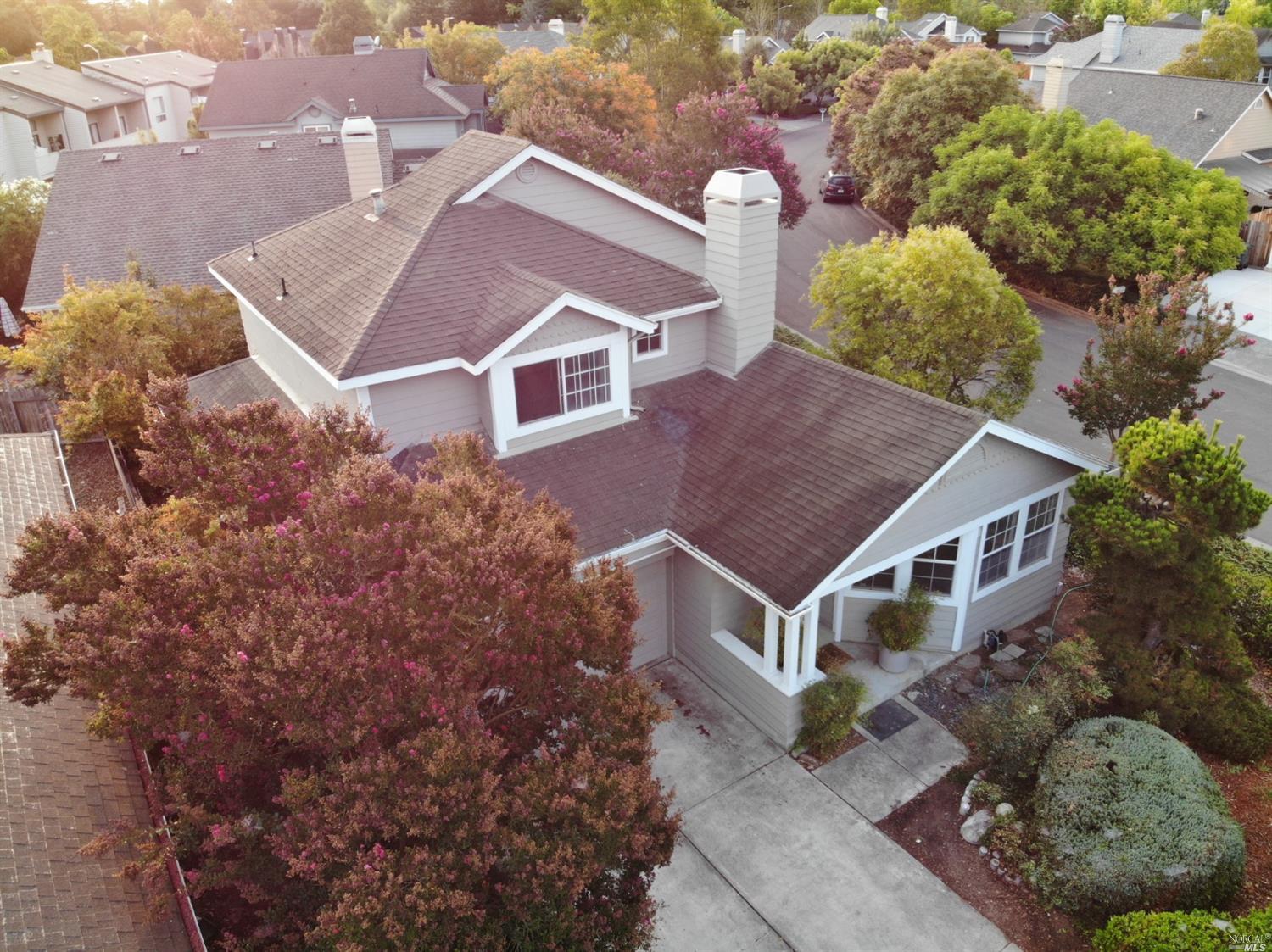an aerial view of a house with a yard and a garage