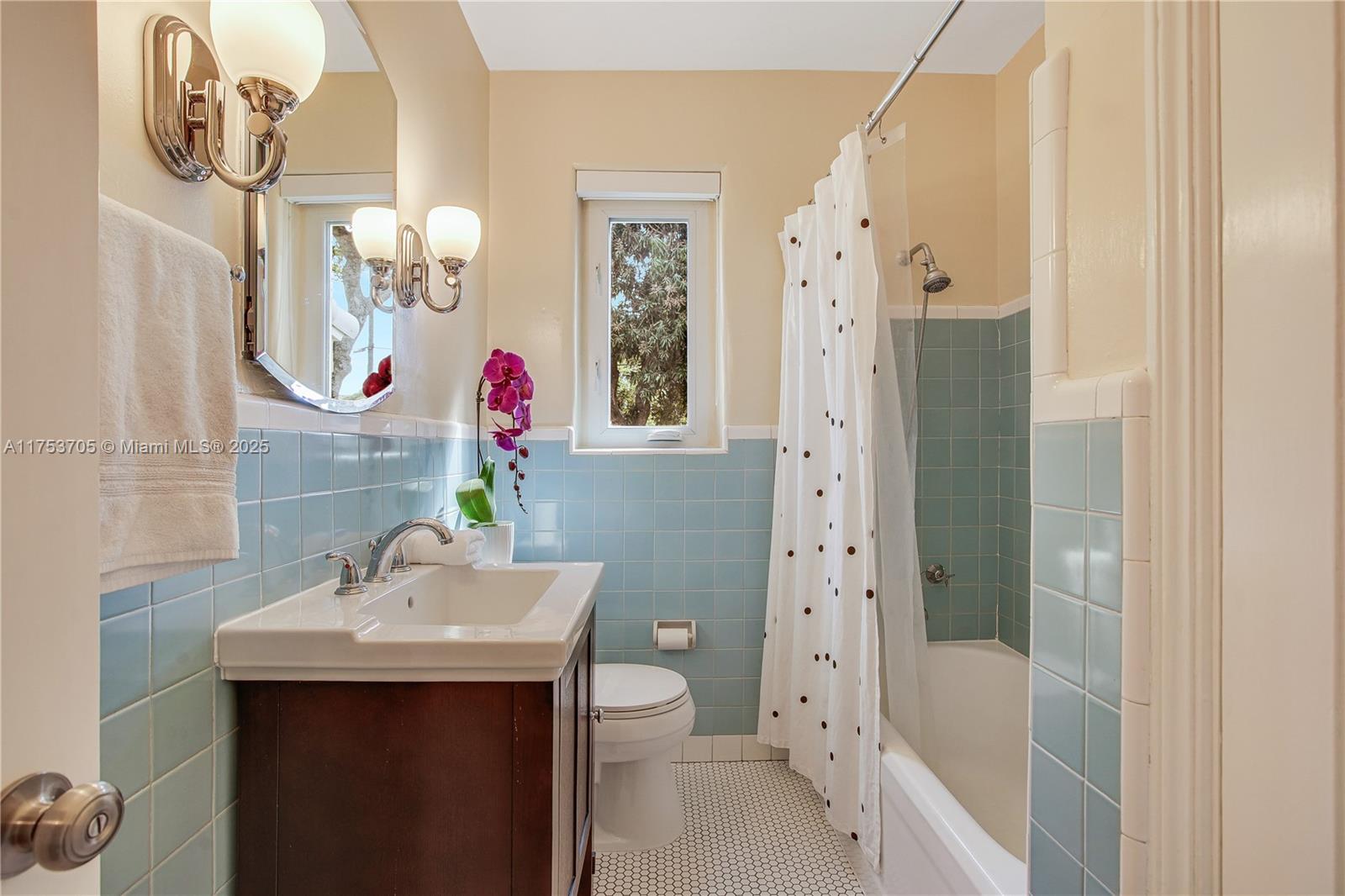 1926 Southwest 17th Terrace Miami, FL 33145 - Photo 20 of 38 a bathroom with a sink mirror and a shower