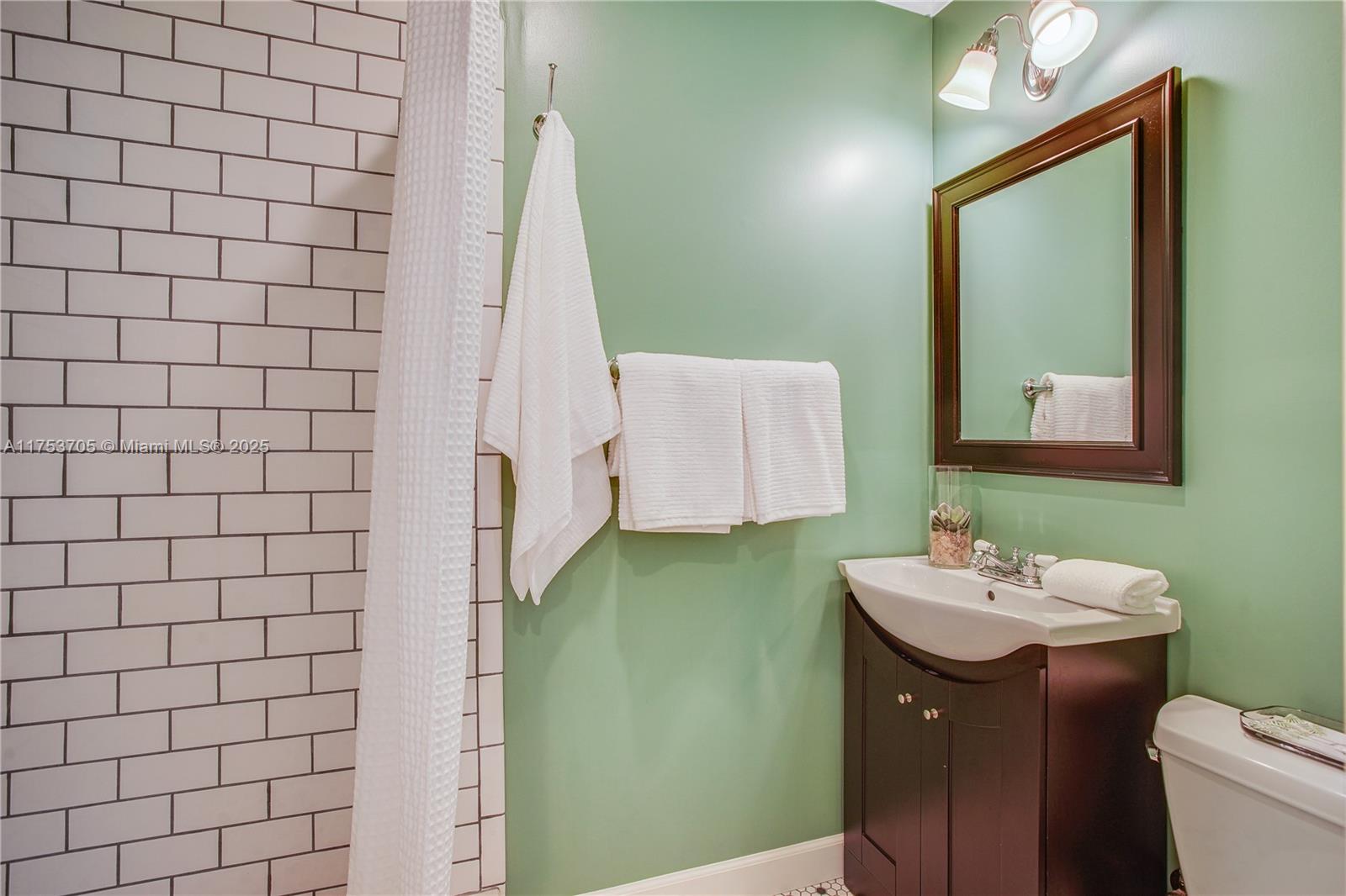 1926 Southwest 17th Terrace Miami, FL 33145 - Photo 21 of 38 a bathroom with a sink a toilet and mirror