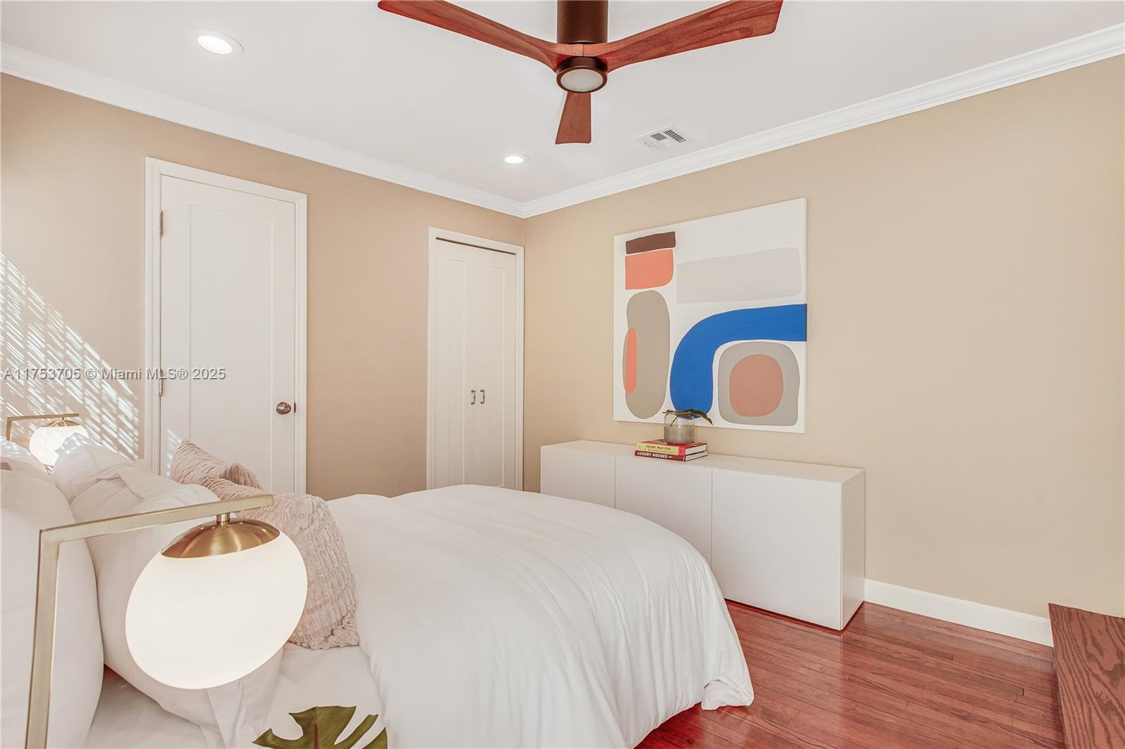 1926 Southwest 17th Terrace Miami, FL 33145 - Photo 24 of 38 a bedroom with a bed a dresser and wooden floor
