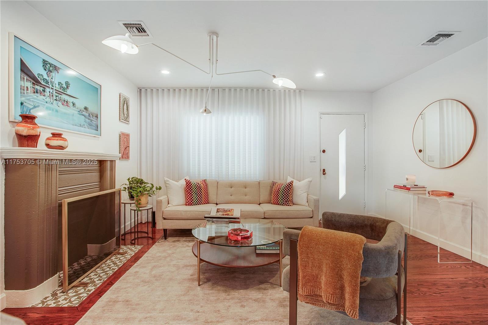 1926 Southwest 17th Terrace Miami, FL 33145 - Photo 5 of 38 a living room with furniture a flat screen tv and a fireplace