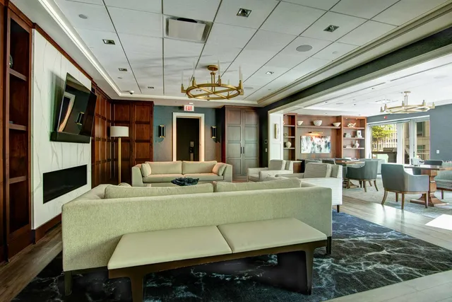 a spacious bathroom with a potted plant and a sink