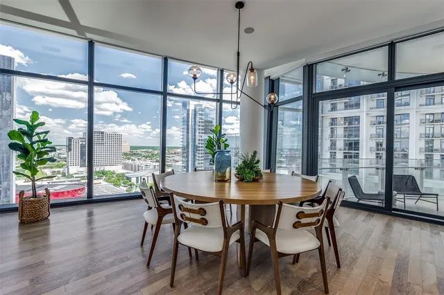 a view of a dining room with furniture window and wooden floor