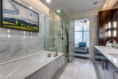 a bathroom with a tub a sink and a shower