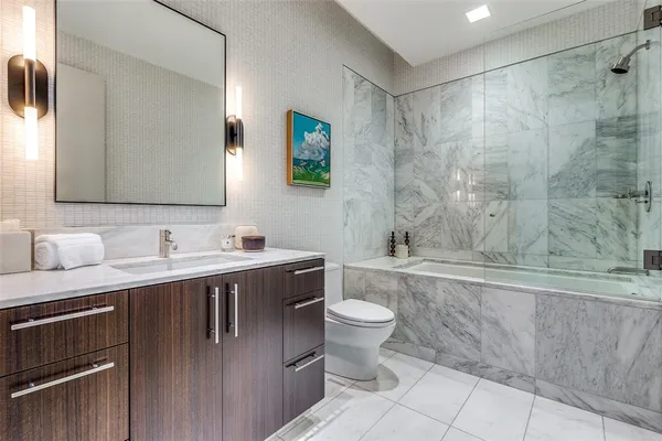 a bathroom with a sink a toilet and bathtub