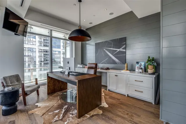 a kitchen with stainless steel appliances granite countertop a stove and a wooden floors