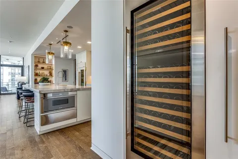 a view of kitchen and hallway with wooden floor