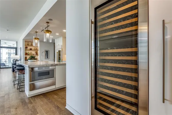 a view of kitchen and hallway with wooden floor