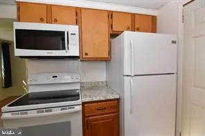 a white refrigerator freezer sitting in a kitchen