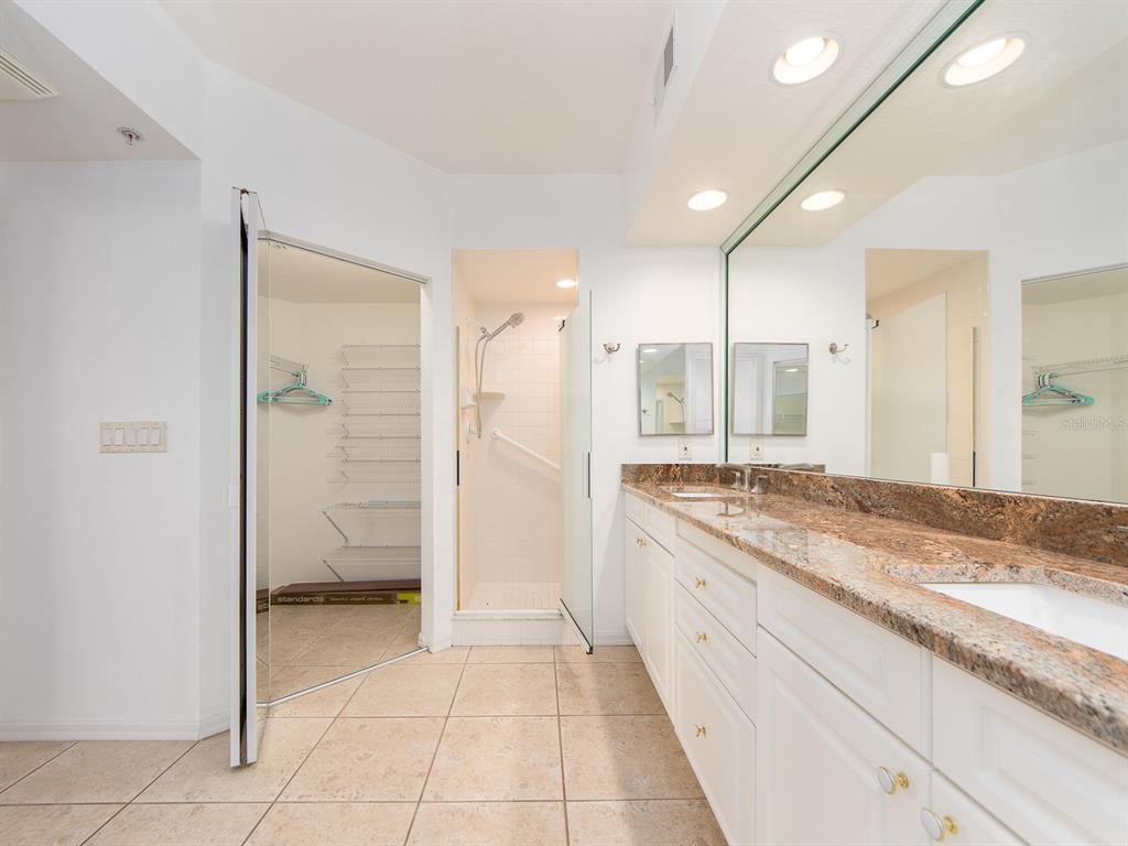 6550 Shoreline Drive, Unit 7502 St. Petersburg, FL 33708 - Photo 17 of 30 a bathroom with a granite countertop sink mirror and a