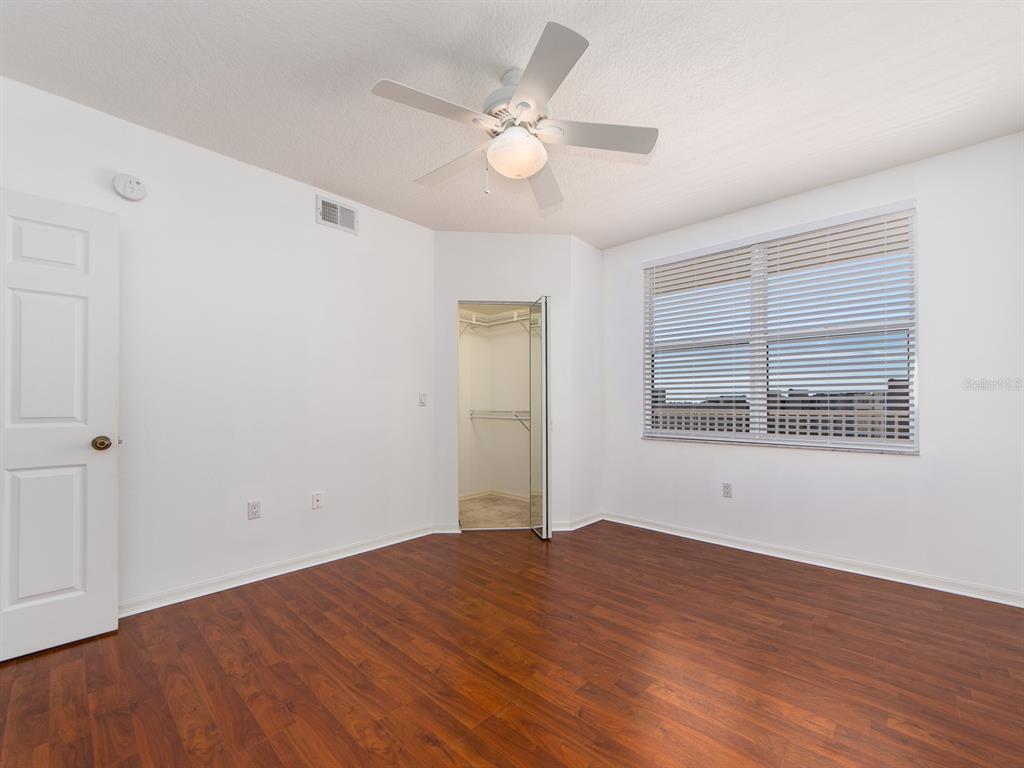 6550 Shoreline Drive, Unit 7502 St. Petersburg, FL 33708 - Photo 19 of 30 a view of an empty room with wooden floor and a window