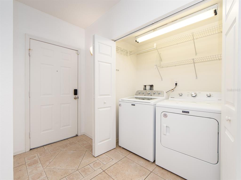 6550 Shoreline Drive, Unit 7502 St. Petersburg, FL 33708 - Photo 7 of 30 a utility room with cabinets washer and dryer