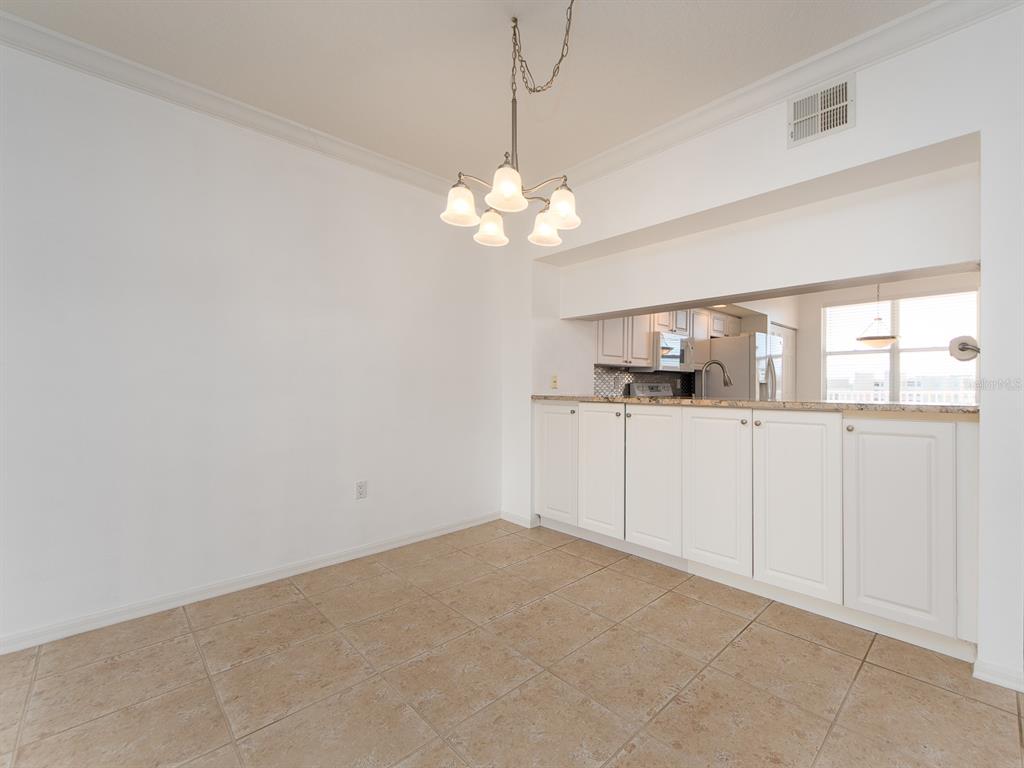 6550 Shoreline Drive, Unit 7502 St. Petersburg, FL 33708 - Photo 8 of 30 a view of a kitchen with a microwave and a window