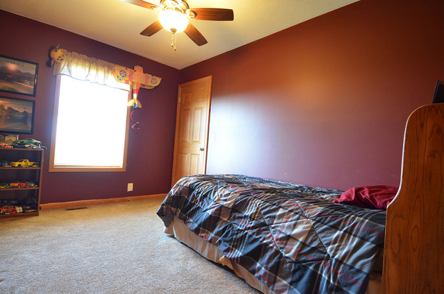 3503 East 10th Road Utica, IL 61373 - Photo 7 of 14 a bedroom with a bed and a chandelier