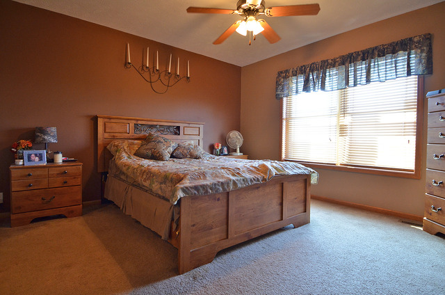 3503 East 10th Road Utica, IL 61373 - Photo 9 of 14 a bedroom with a bed and a chandelier