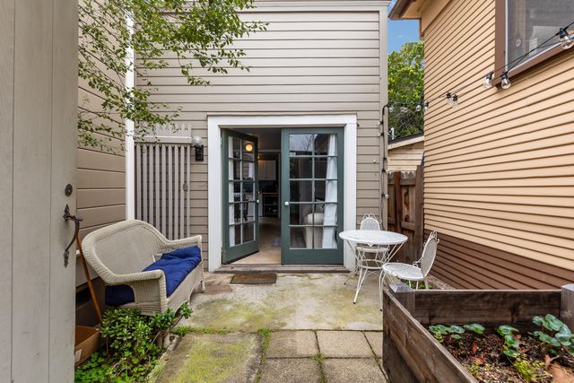 a view of a patio with chair and tables back yard of the house