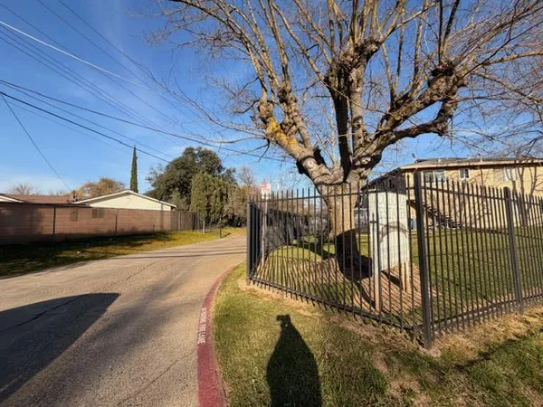 a view of a backyard with wooden fence
