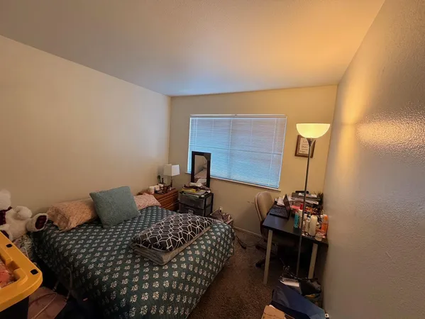 a bedroom with furniture and a mirror