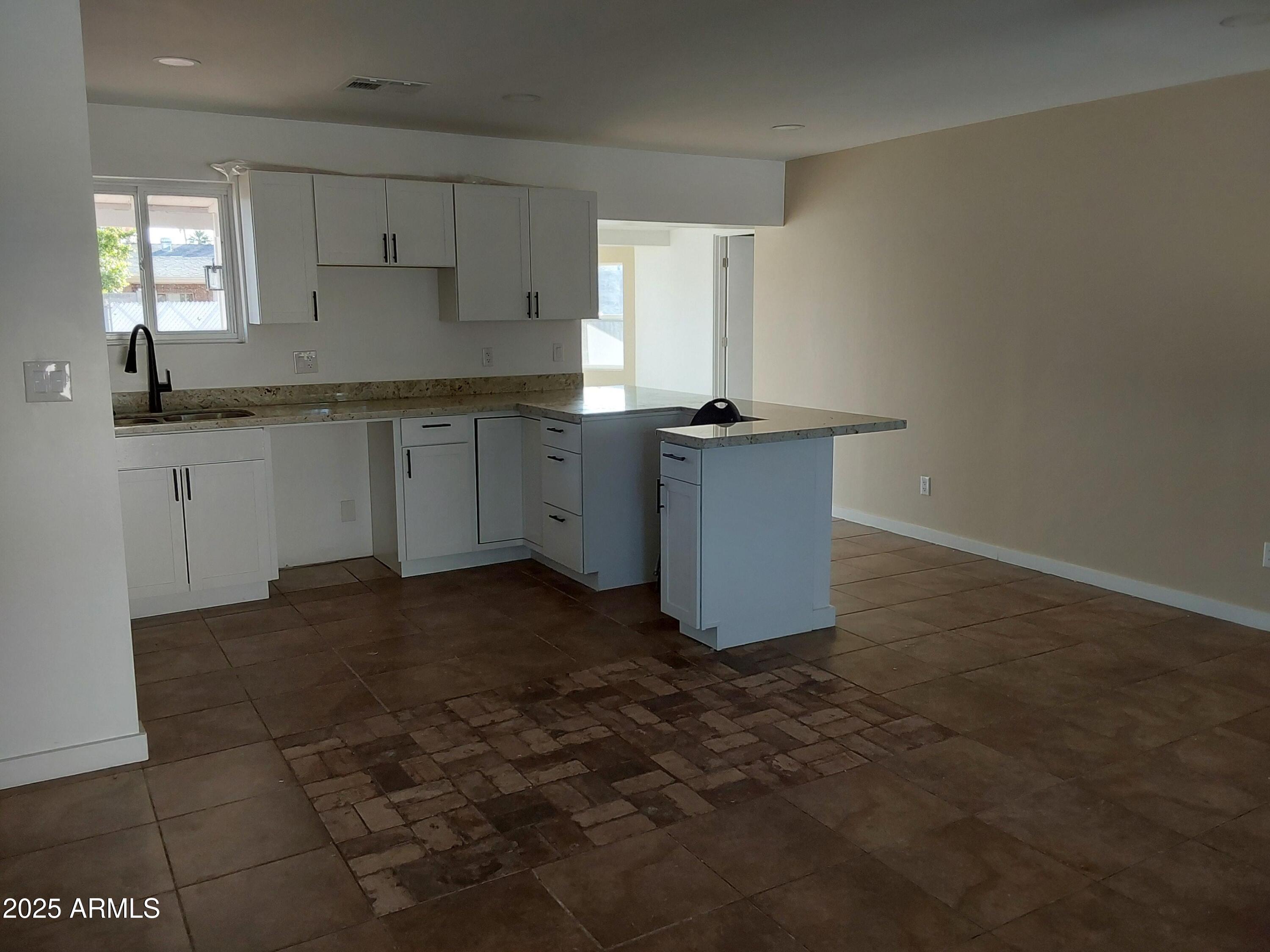 715 East Taylor Street Tempe, AZ 85288 - Photo 14 of 29 a kitchen with a sink cabinets and window