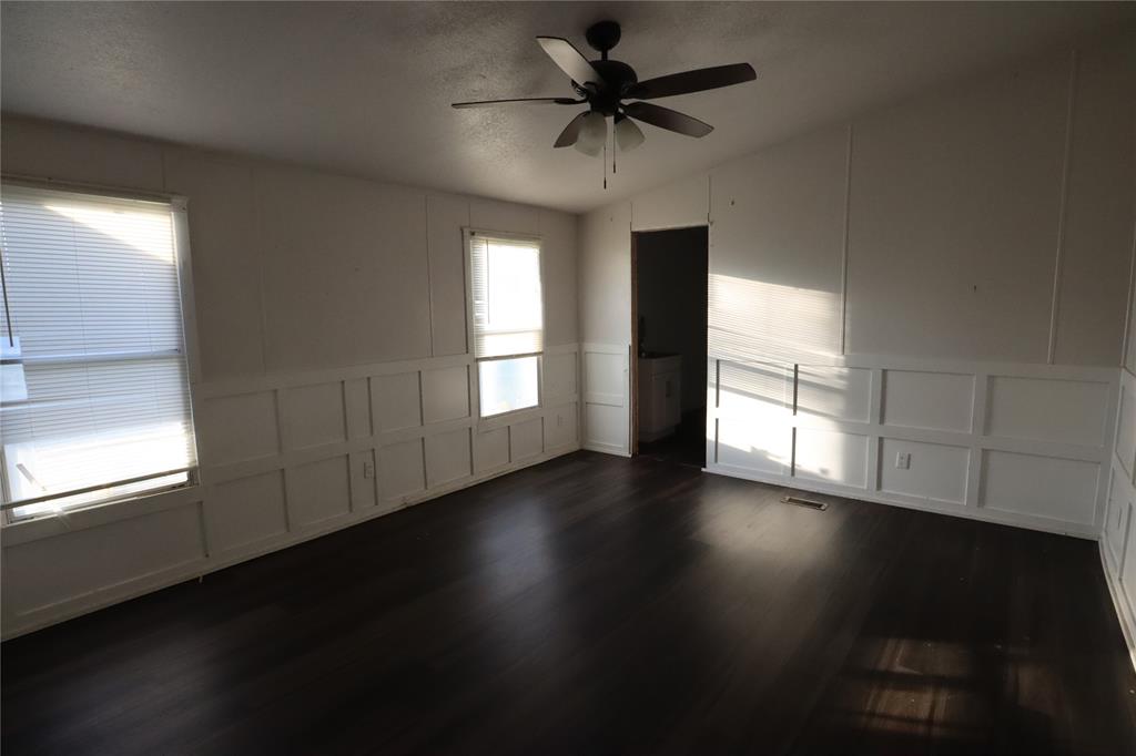 1437 West Loop 254 Ranger, TX 76470 - Photo 11 of 27 a view of an empty room with wooden floor and a window