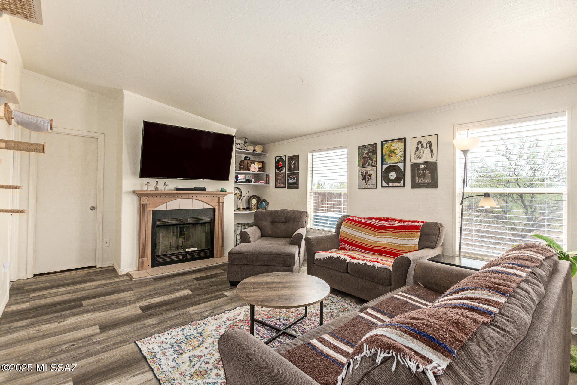 5386 North Whitetail Road Marana, AZ 85653 - Photo 8 of 33 a living room with furniture a fireplace and a flat screen tv