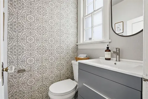 a bathroom with a sink a toilet and a mirror