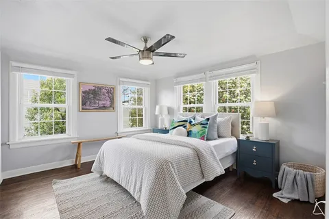 a bedroom with a bed and wooden floor