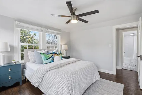a bedroom with a bed and a large window