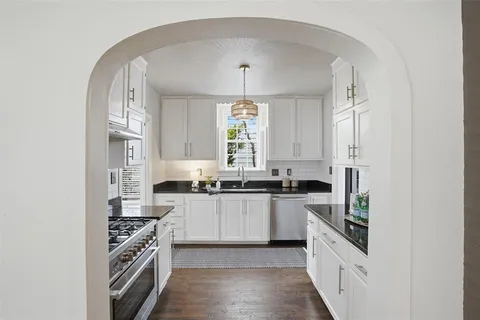 a kitchen with stainless steel appliances a stove sink and cabinets