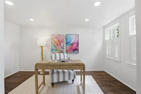a view of a room with furniture and wooden floor