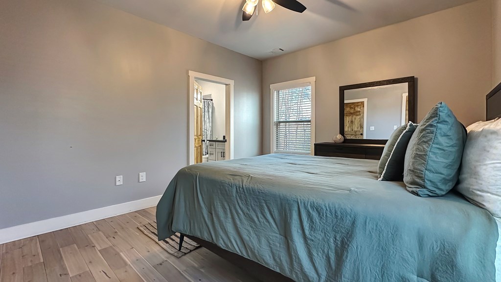 374 Prince Drive Morganton, GA 30560 - Photo 27 of 60 a bedroom with a bed and a chandelier