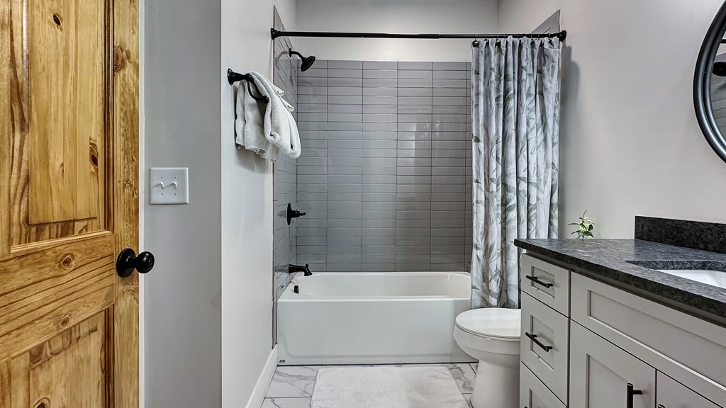 374 Prince Drive Morganton, GA 30560 - Photo 29 of 60 a bathroom with a granite countertop bathtub shower sink vanity and toilet