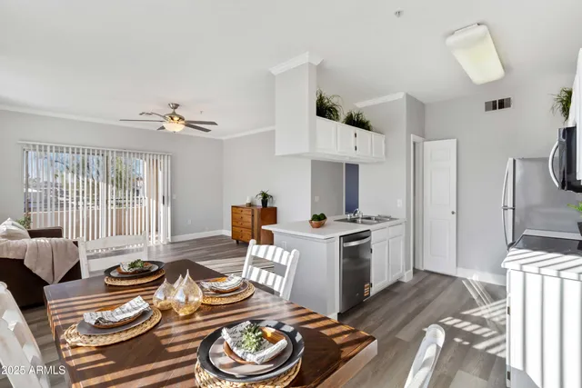 a kitchen with a stove and a wooden floor