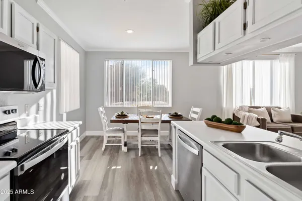 a kitchen with a sink stove and cabinets
