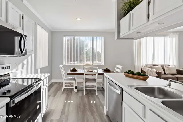 a kitchen with a sink stove and cabinets
