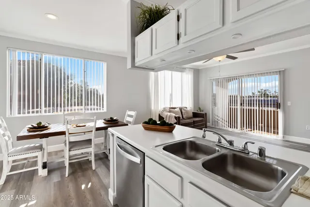 a kitchen with a sink stove and cabinets
