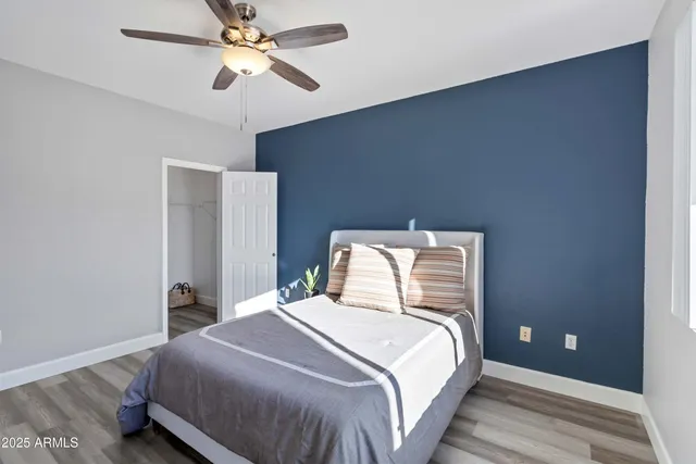 a bedroom with a bed and a ceiling fan