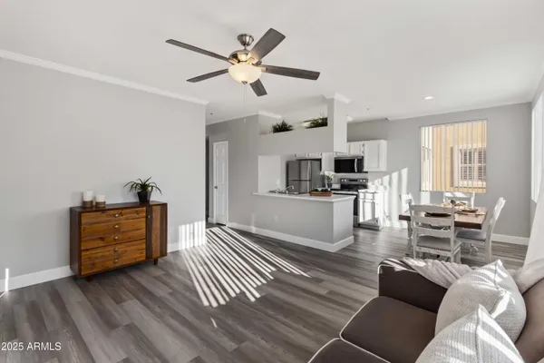 a living room with furniture and kitchen view