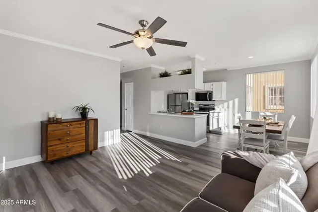 a living room with furniture and kitchen view