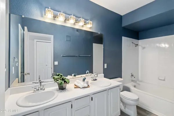 a bathroom with a sink and mirror with toilet