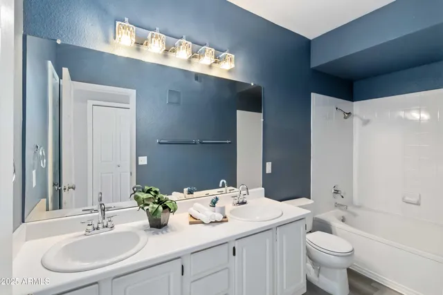 a bathroom with a sink and mirror with toilet