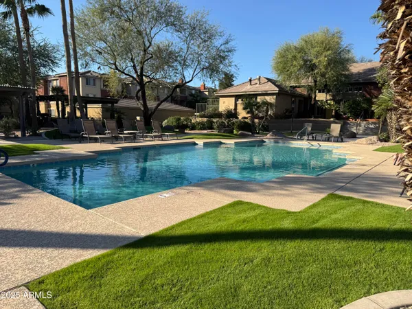 a view of a house with swimming pool and a yard