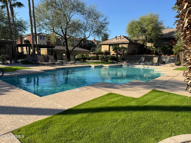 a view of a house with swimming pool and a yard