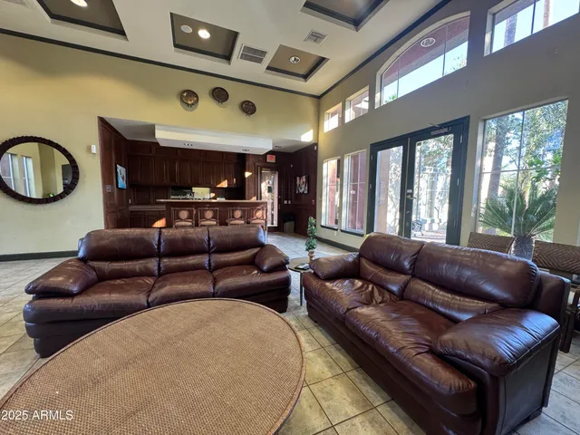 a living room with furniture a fireplace and a large window