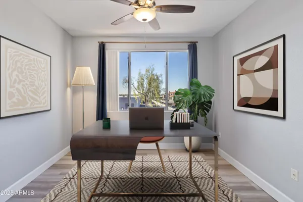 a living room with furniture and a potted plant