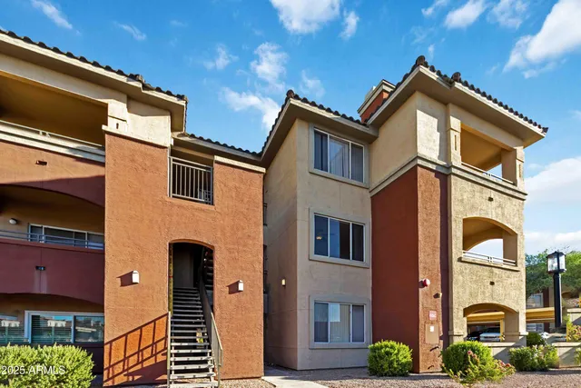 a front view of a residential apartment building with a yard